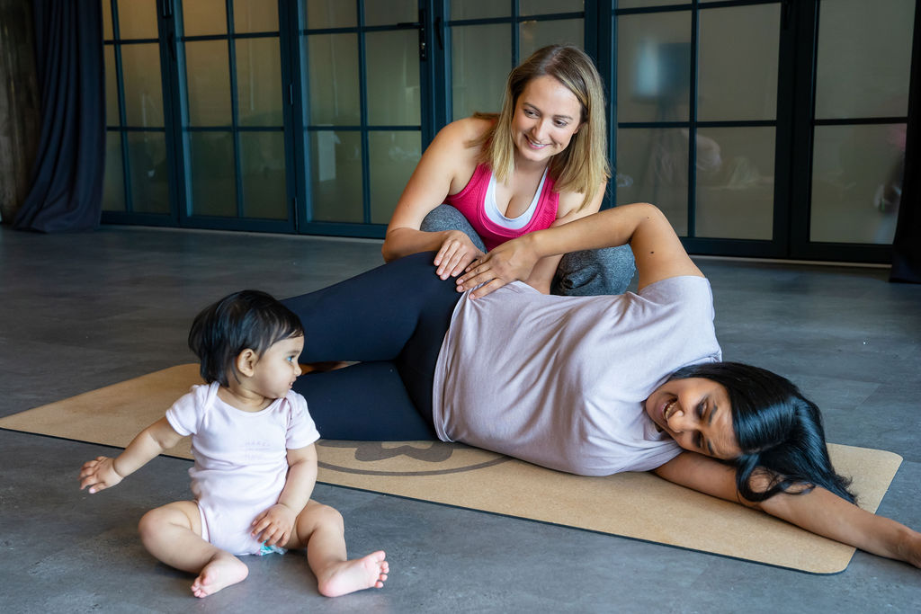 woman and baby doing postpartum exercises